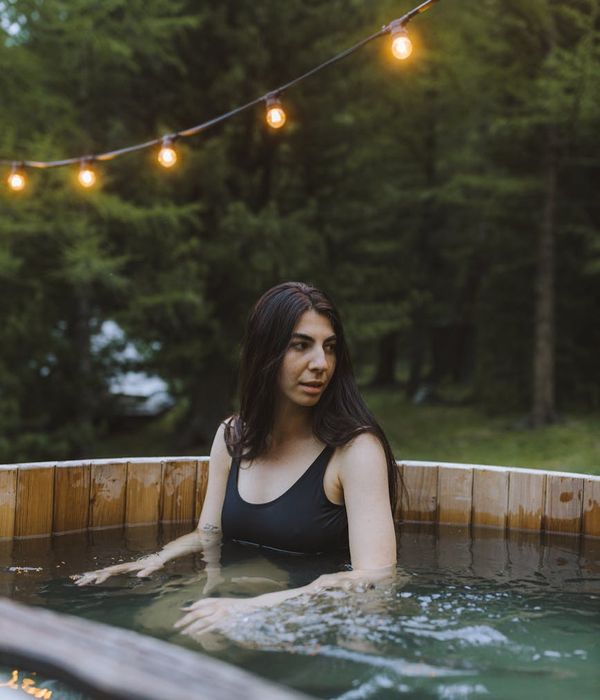 Person meditating peacefully in a natural outdoor setting.